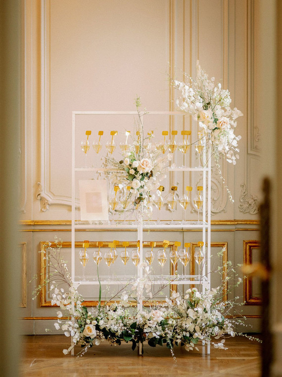 Champagne escort card display with gold drink stirs