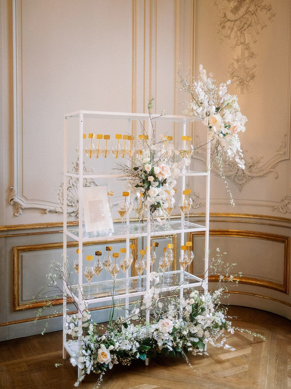 Champagne escort card display with gold drink stirs