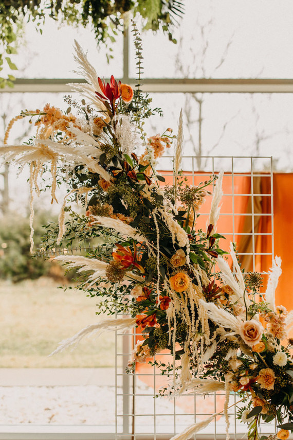 lush modern boho wedding ceremony floral installation