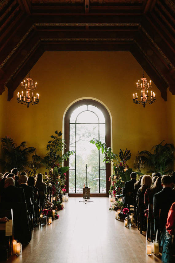 dramatic hollywood wedding ceremony with tropical plants
