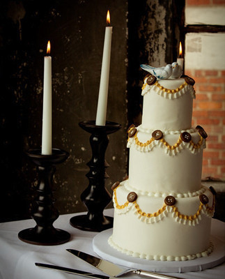 Three tiered cake with buttons and birds