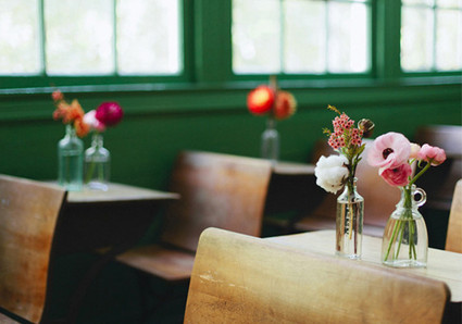 wooden desks and whiskey bottle vases