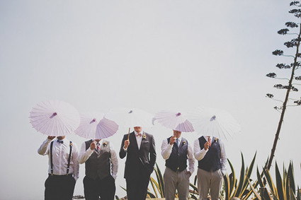 Groomsmen with pink umbrellas