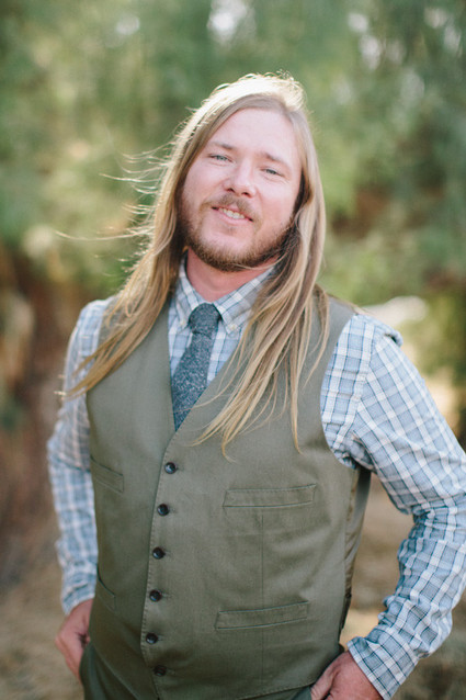 Groom with green vest and blue striped shirt