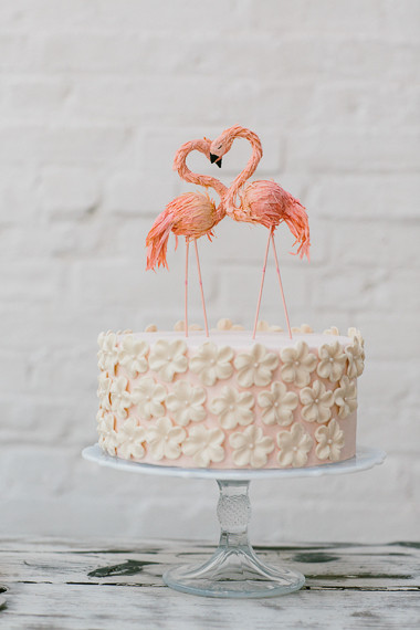 Pink cake with flamingo cake topper