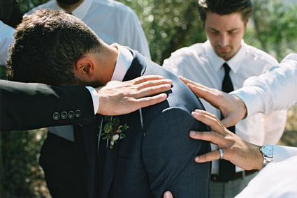 Groomsmen pray