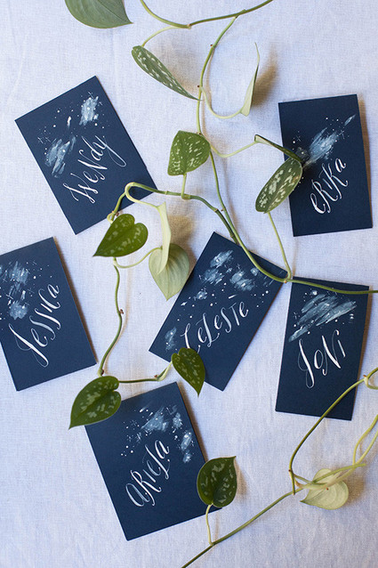 Blue escort cards with white calligraphy
