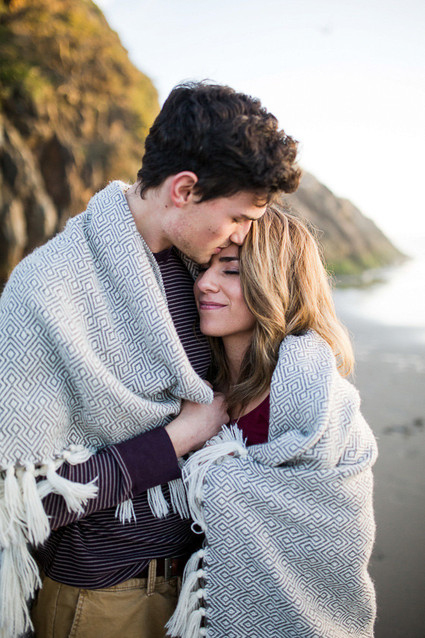 Beach blanket engagement photo