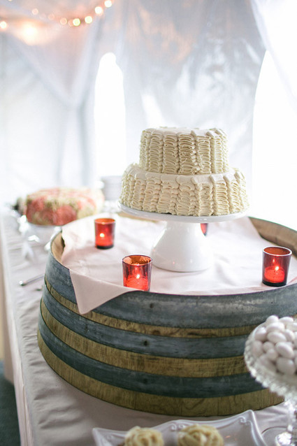 White ruffled cake with barrel stand