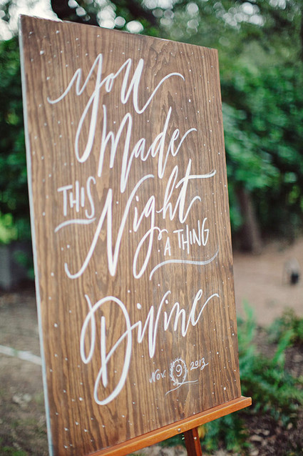 Wood signage with white calligraphy