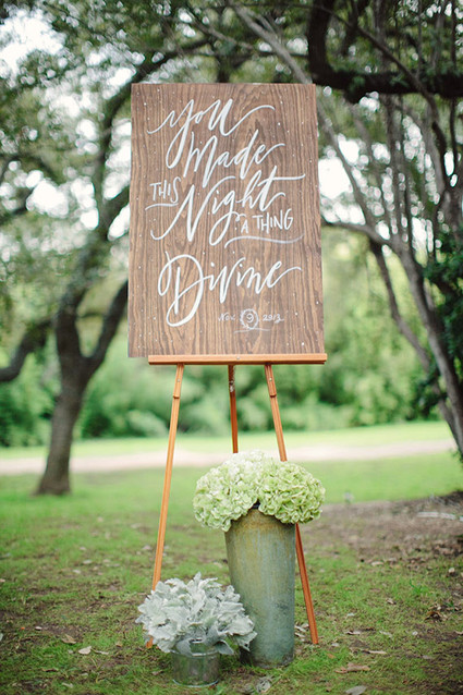 Wooden signage with white calligraphy
