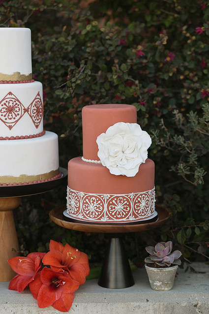 Spanish inspired deep red cake with white floral decor
