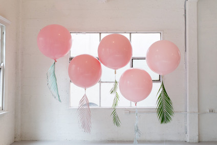 Pink balloons with tropical foliage