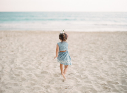 little girls on the beach with flower crowns and watermelon