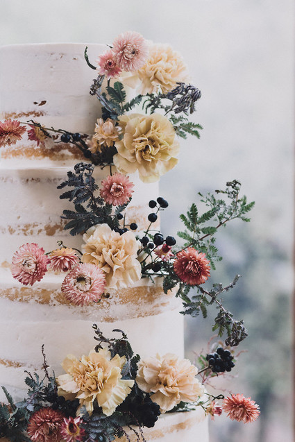 Tiered layer cake with strawflowers and chrysanthemums