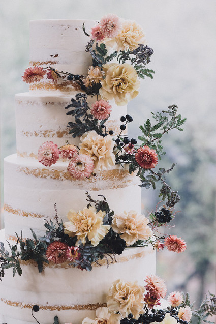 Tiered layer cake with strawflowers and chrysanthemums