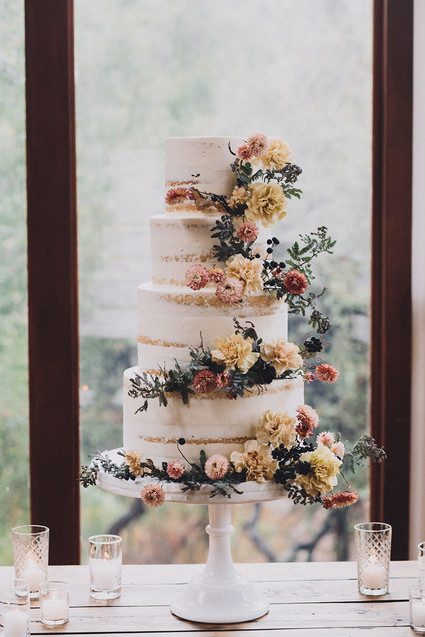 Tiered layer cake with strawflowers and chrysanthemums