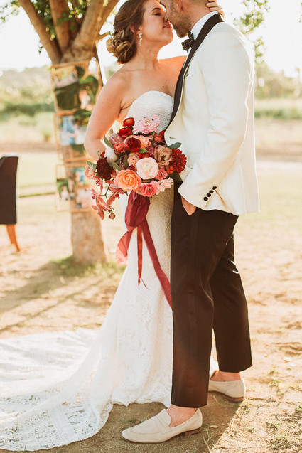 Groom in white dinner jacket at Flora Farms wedding on 100 Layer Cake