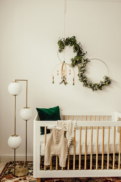 Gender neutral gold and emerald boho nursery