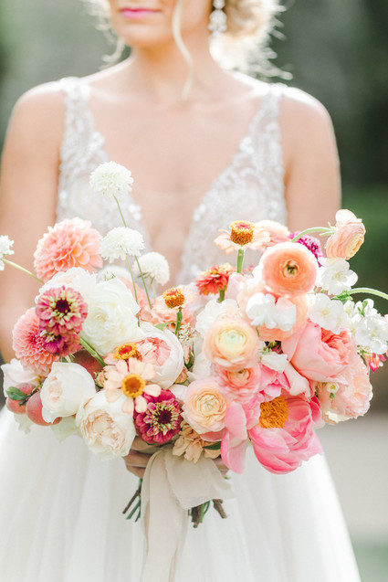 Colorful modern wedding with a killer tropical floral installation