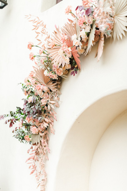 Colorful modern wedding with a killer tropical floral installation