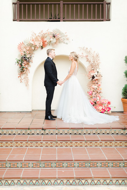 Colorful modern wedding with a killer tropical floral installation