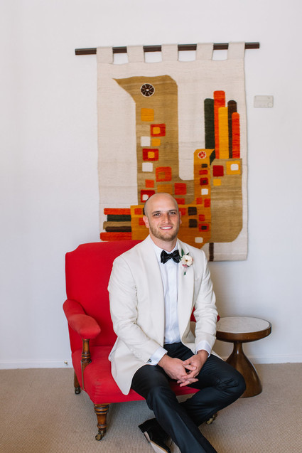 Groom in white tux jacket