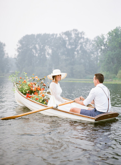 End of summer retro engagement shoot in a rowboat full of flowers