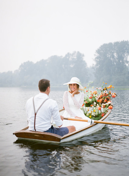 End of summer retro engagement shoot in a rowboat full of flowers