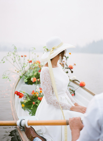 End of summer retro engagement shoot in a rowboat full of flowers