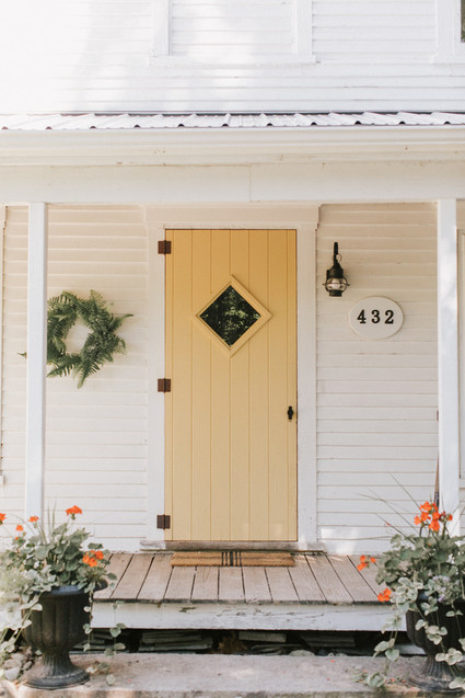simple fall porch with a yellow door