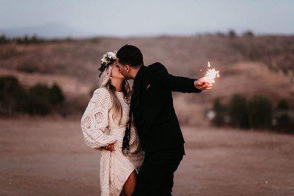Boho vow renewal with a palm frond teepee at Wolf Feather Honey Farm