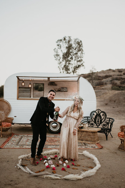 Boho vow renewal with a palm frond teepee at Wolf Feather Honey Farm
