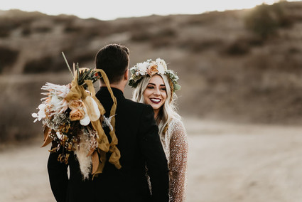 Boho vow renewal with a palm frond teepee at Wolf Feather Honey Farm