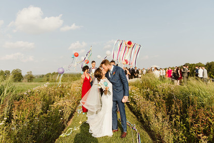 Farm to table summer barn wedding with pops of red and a PARADE