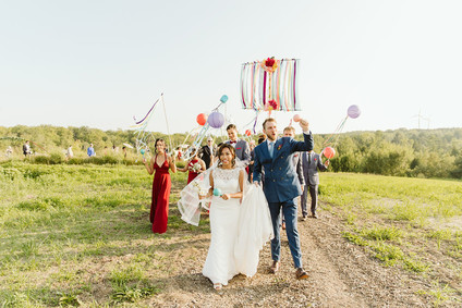 Farm to table summer barn wedding with pops of red and a PARADE