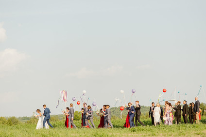 Farm to table summer barn wedding with pops of red and a PARADE