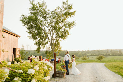 Farm to table summer barn wedding with pops of red and a PARADE