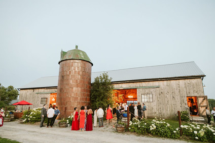 Farm to table summer barn wedding with pops of red and a PARADE