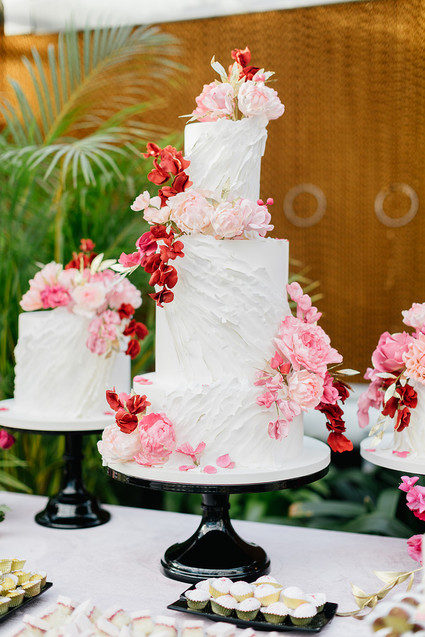 Ruffled floral wedding cake with pink details
