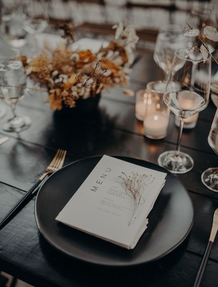 black place setting with dried flowers