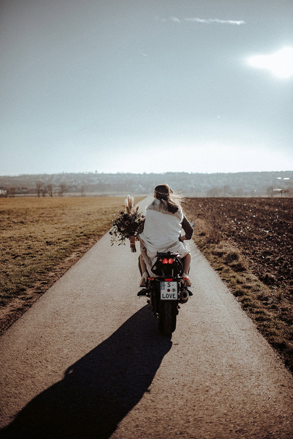 Bride and groom on motorcycle