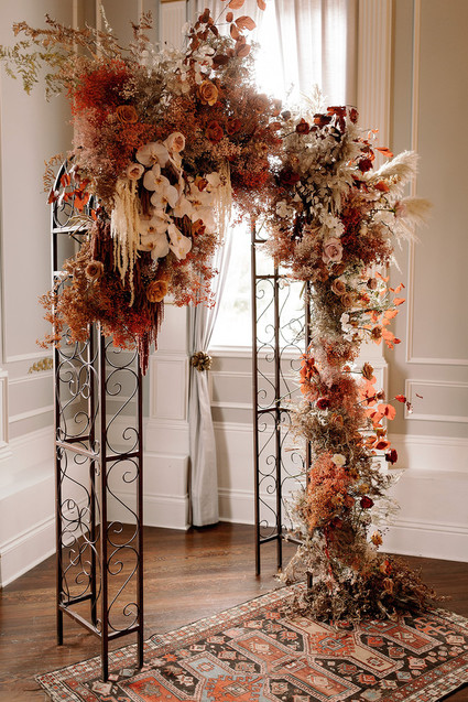 Lush fall floral ceremony arch with pampas
