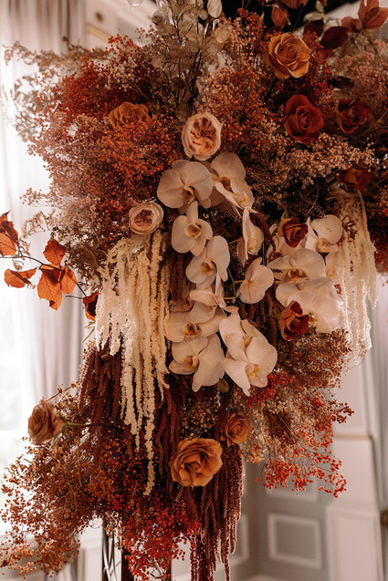 Lush fall floral ceremony arch with pampas