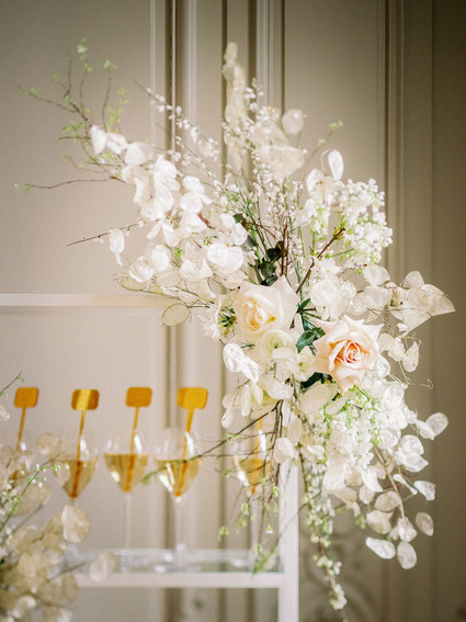 Champagne escort card display with gold drink stirs