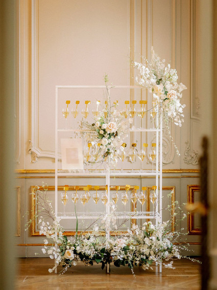 Champagne escort card display with gold drink stirs