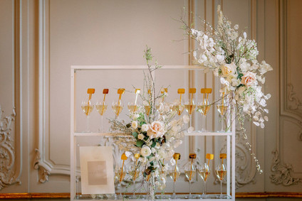 Champagne escort card display with gold drink stirs