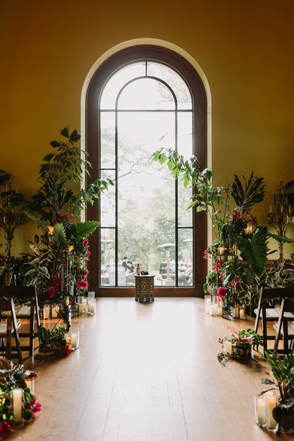 dramatic hollywood wedding ceremony with tropical plants