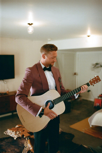 groom playing guitar