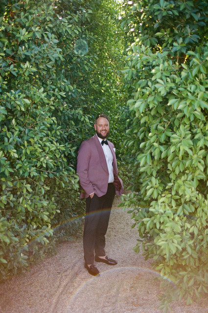 groom in pink suit jacket